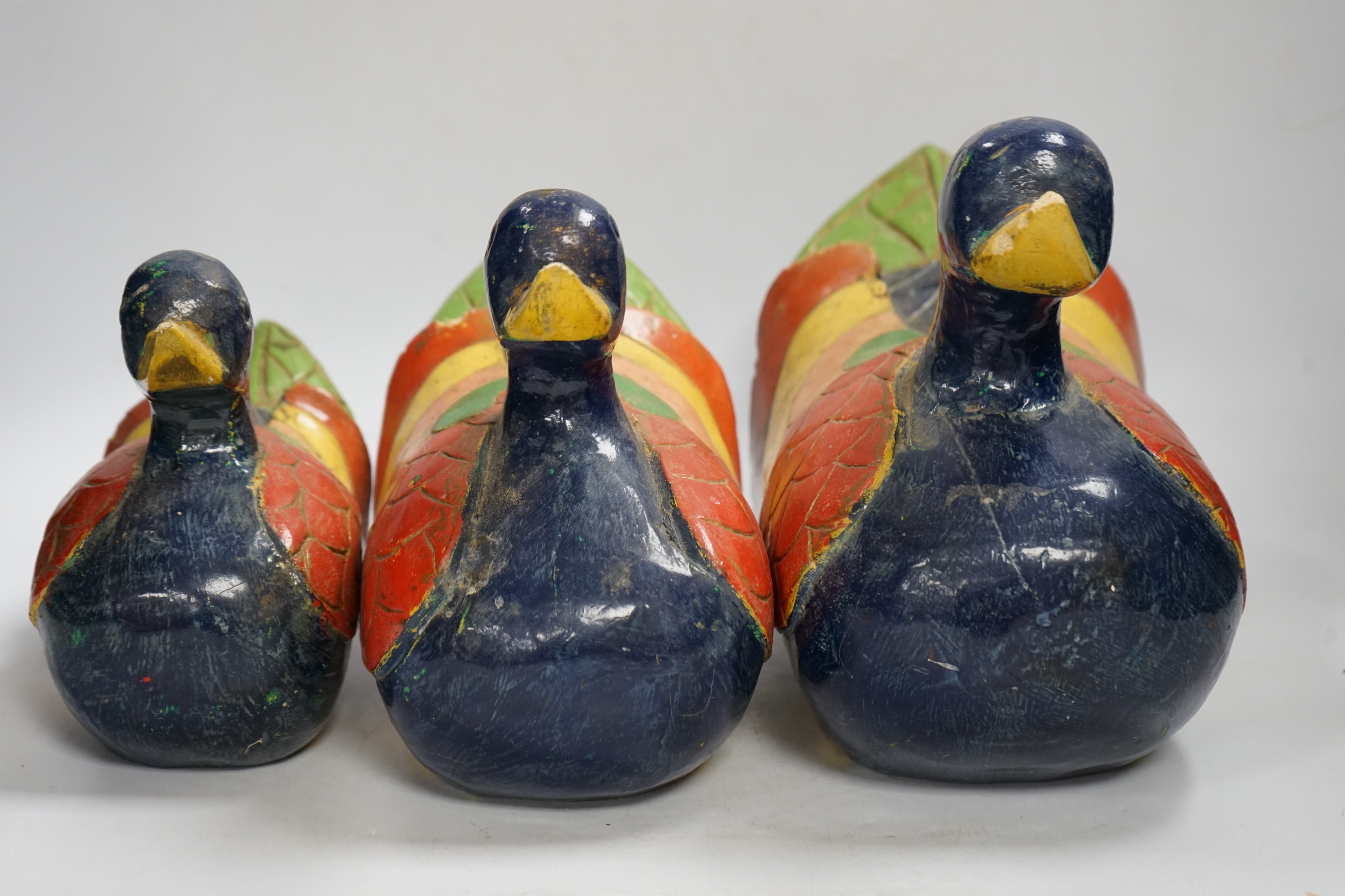 Three graduated carved and painted wood ducks, 31cm